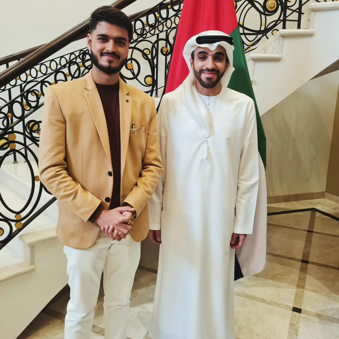 Akshat Mehrotra standing with the Ambassador of the United Arab Emirates.
